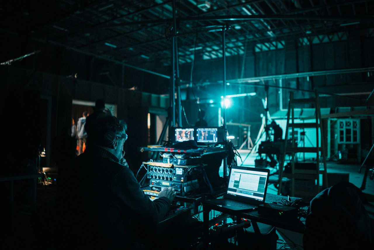 Crafting Captivating Headlines: Your awesome post title goes here Film crew operating technical equipment on a dimly lit set in Budapest, Hungary.